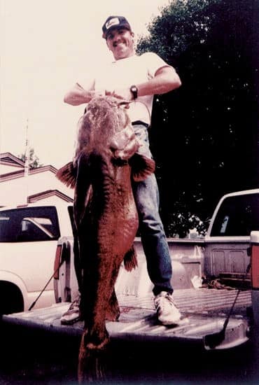 Ken Paulie holding his world-record flathead catfish ©Photo from Jocelyn Harris