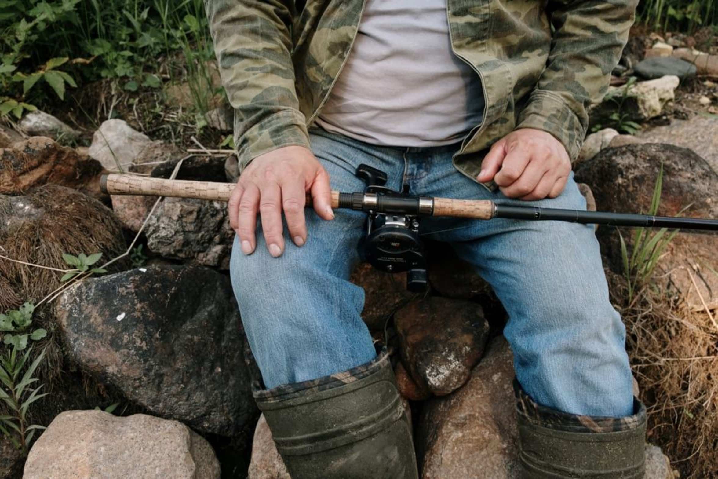 angler holding fishing rod angler holding fishing rod