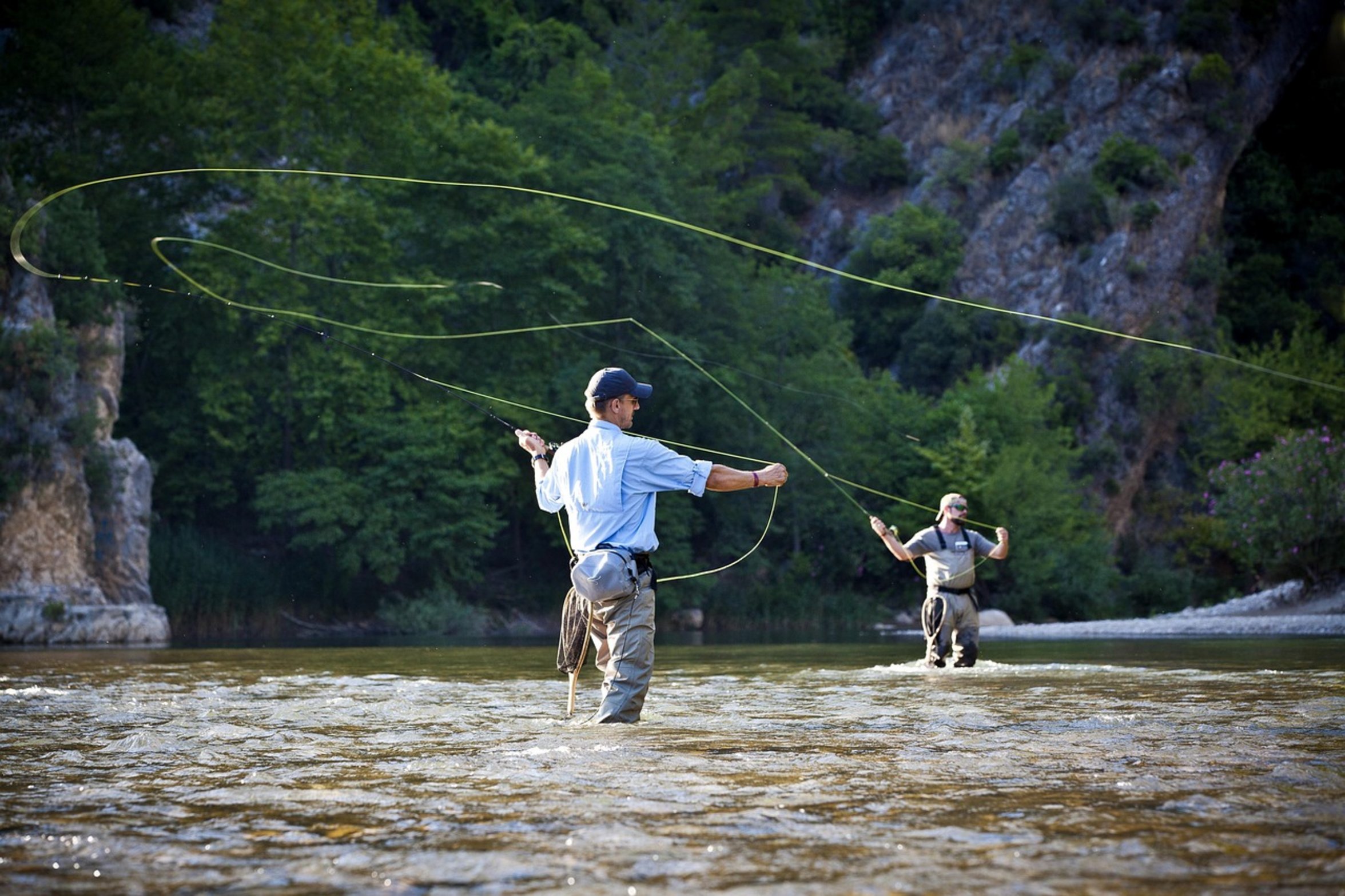 fisherman casting by river fisherman casting by river